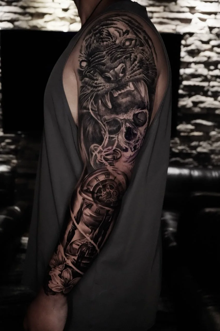 Black and grey tiger, skull, and clock arm sleeve by Courtnie Heller