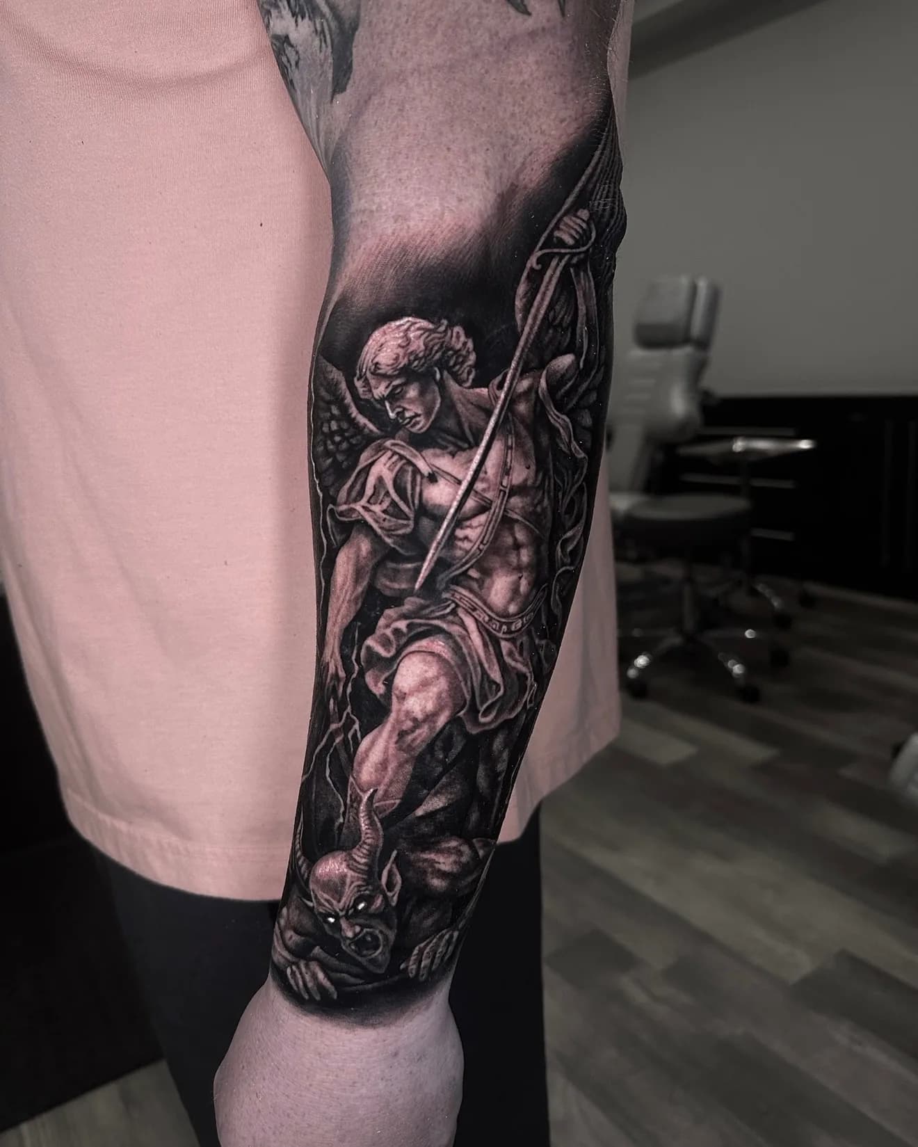 Black and grey Archangel Michael and demon forearm tattoo by Joel Ponce