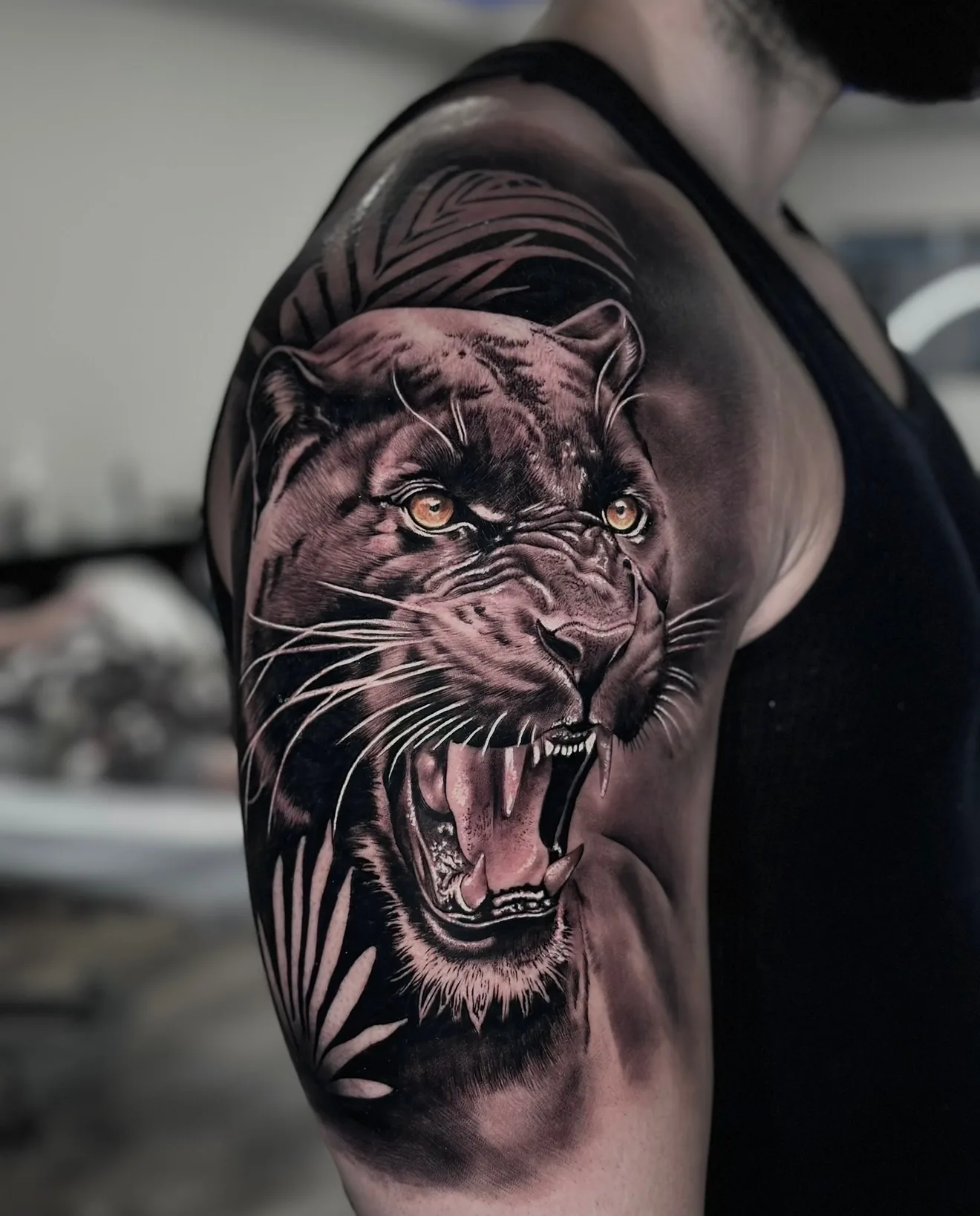 Black and grey realism roaring panther arm tattoo by Joel Ponce