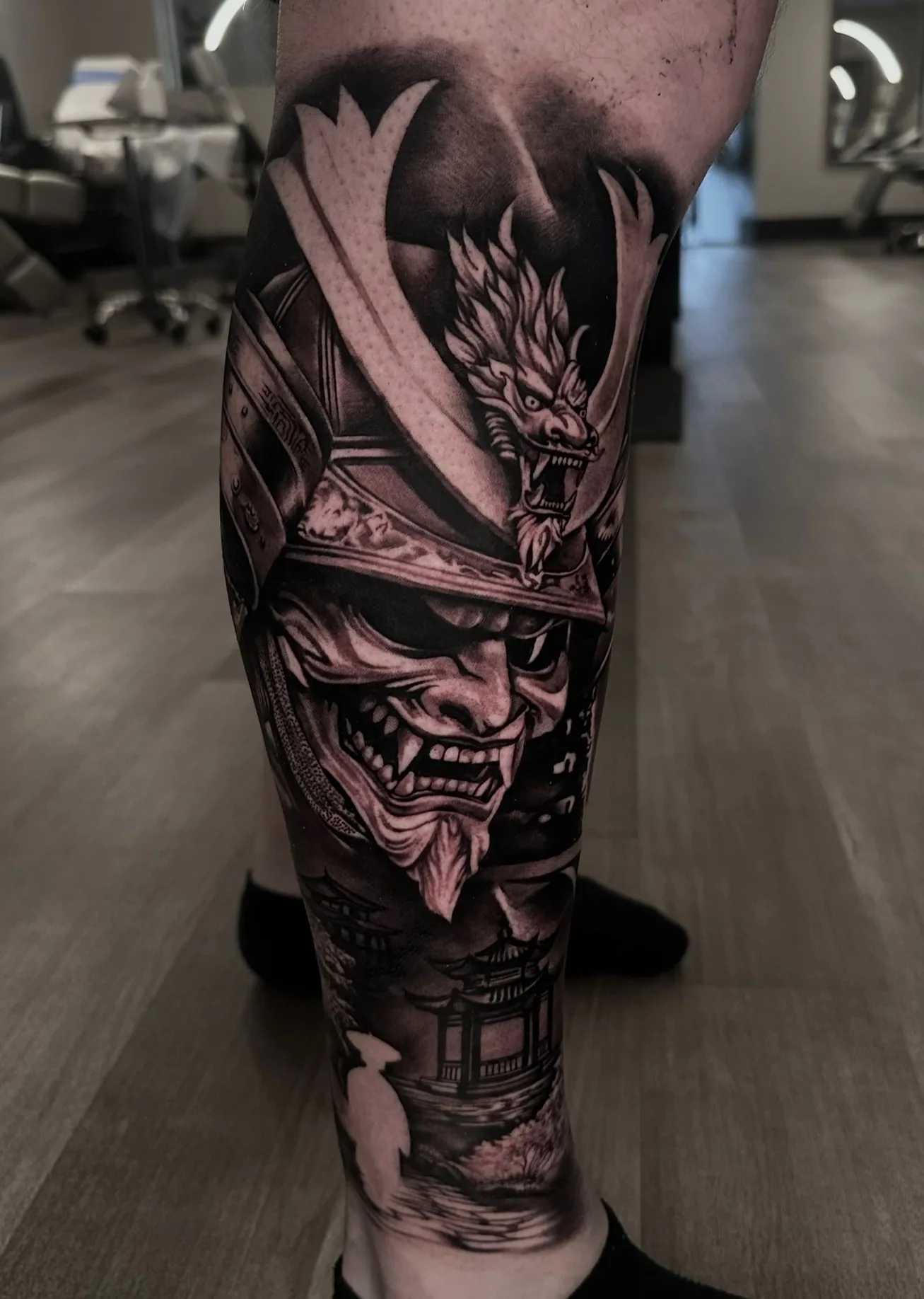 Black and grey samurai and dragon leg sleeve by Joel Ponce
