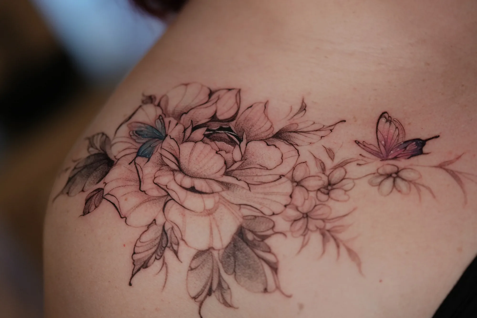 Fine line peony and butterfly shoulder tattoo by Keisha Vo