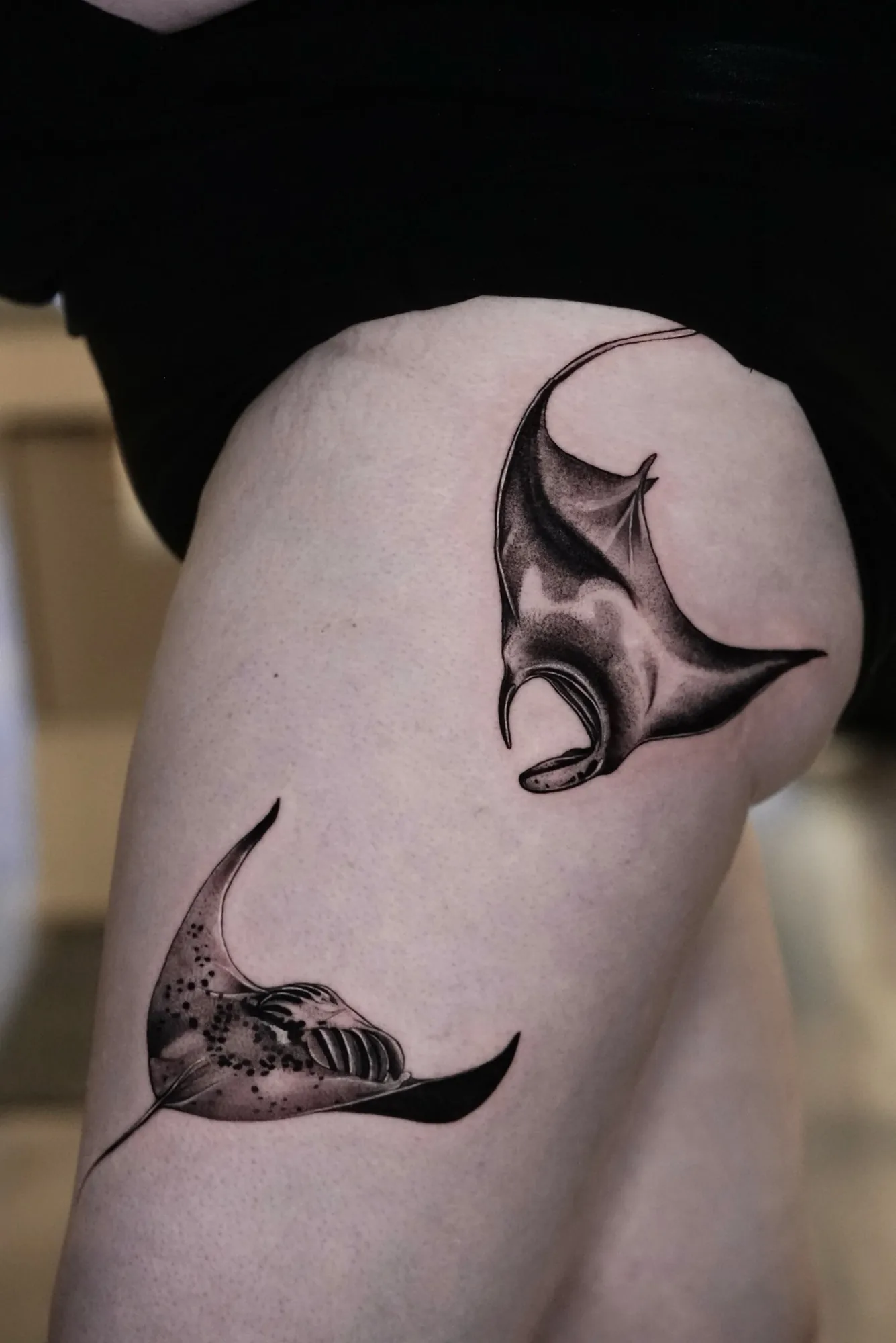 Black and grey manta ray thigh tattoo by Keisha Vo