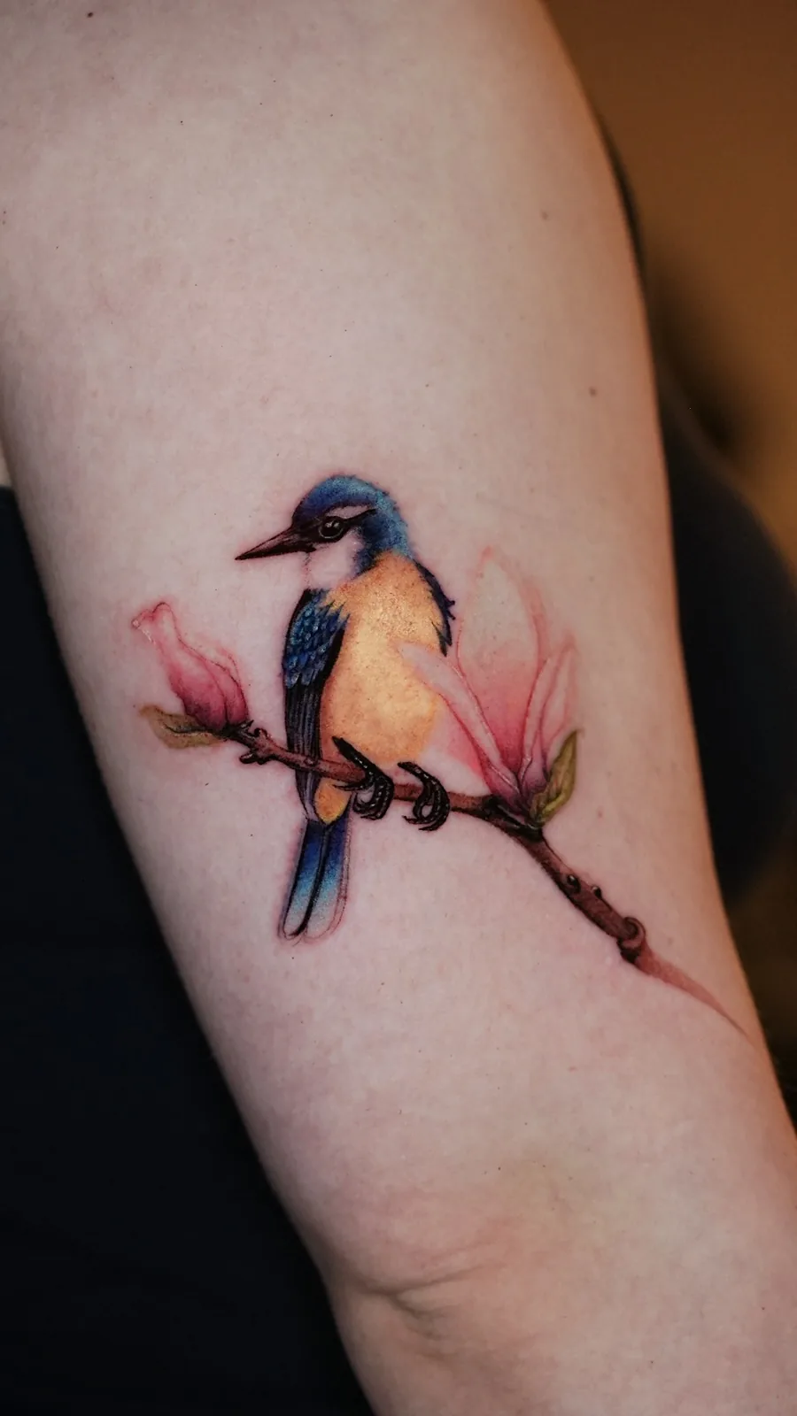 Watercolor kingfisher and magnolia forearm tattoo by Keisha Vo