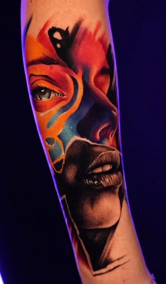Color realism abstract portrait forearm tattoo by Nate Cummings