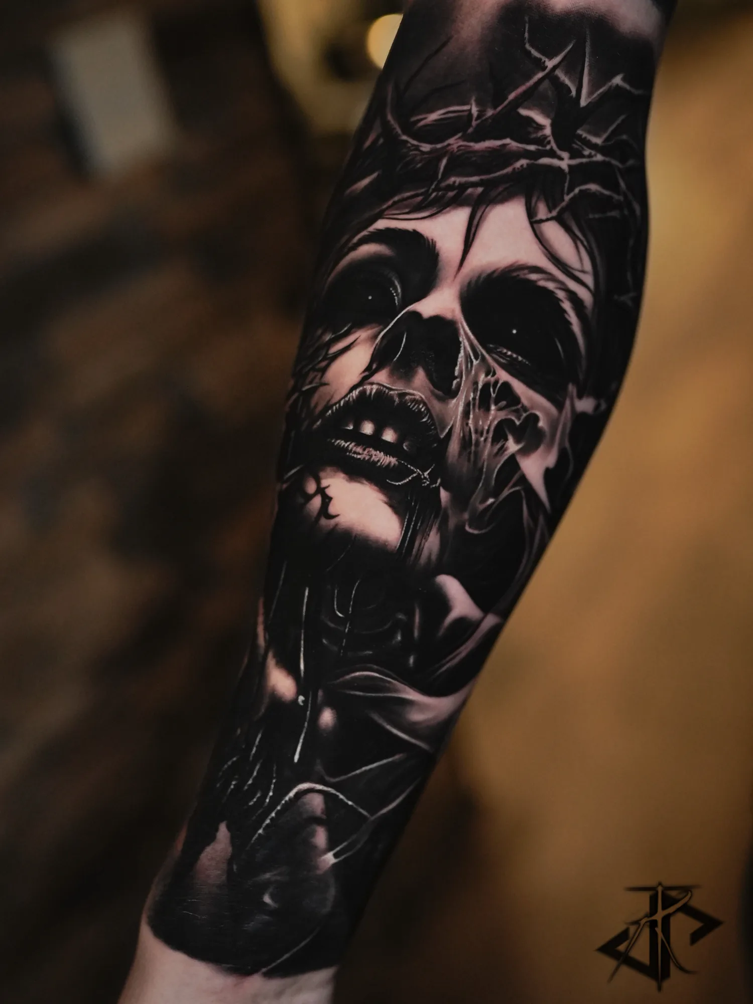 Dark black and grey skull and portrait forearm tattoo by Taro Bushido