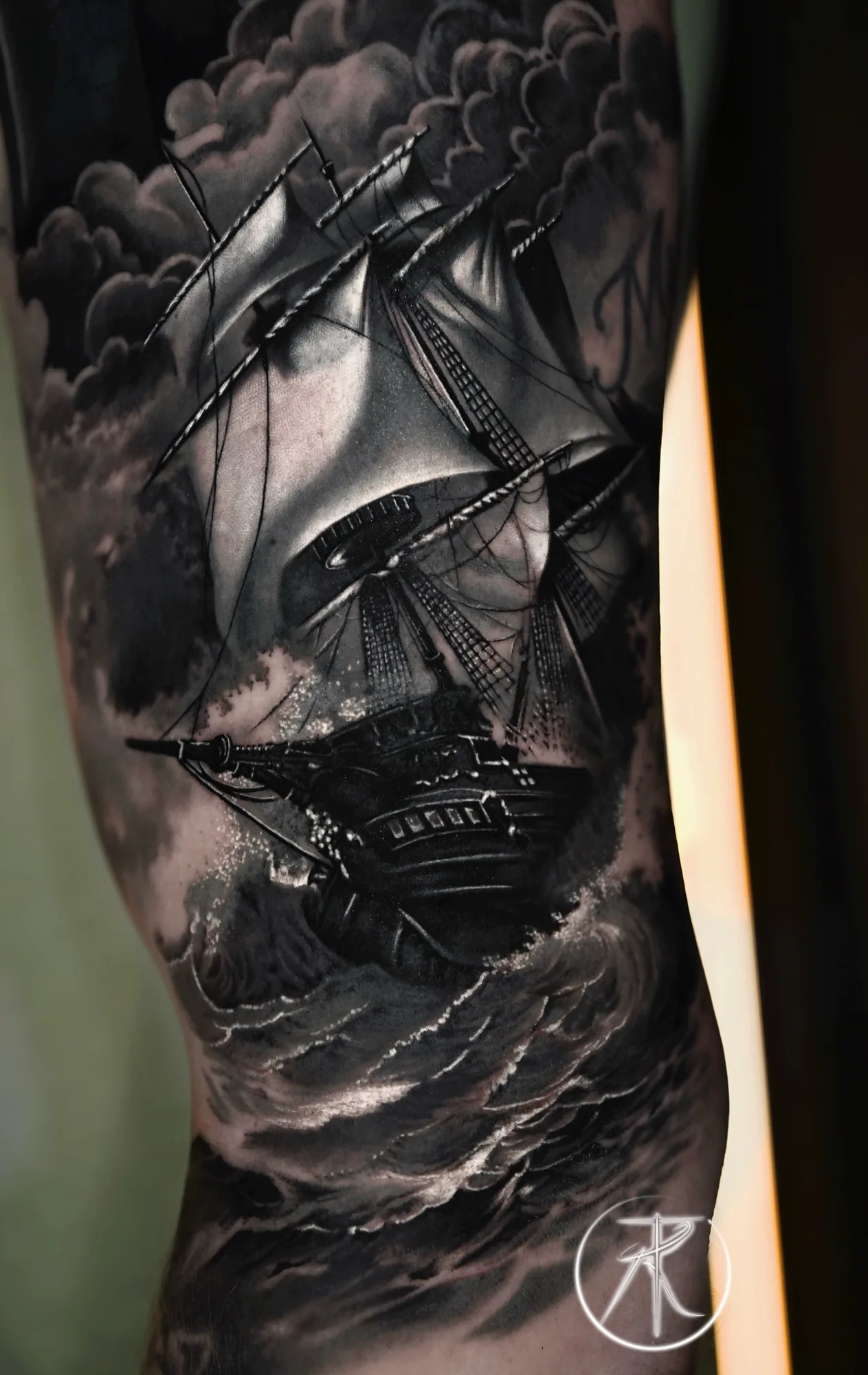 Black and grey ship in a storm sleeve tattoo by Taro Bushido