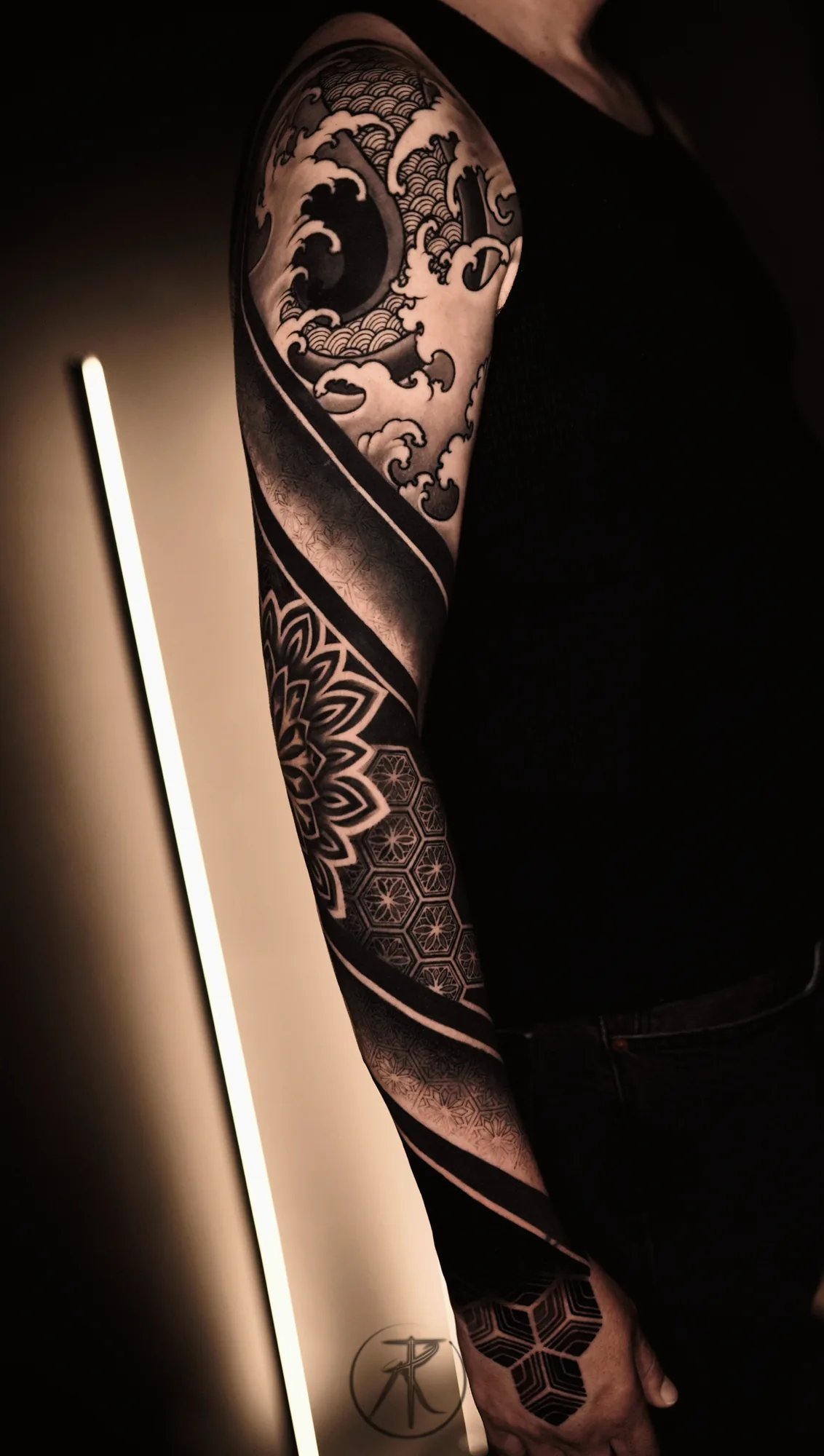 Japanese wave and geometric mandala sleeve tattoo by Taro Bushido