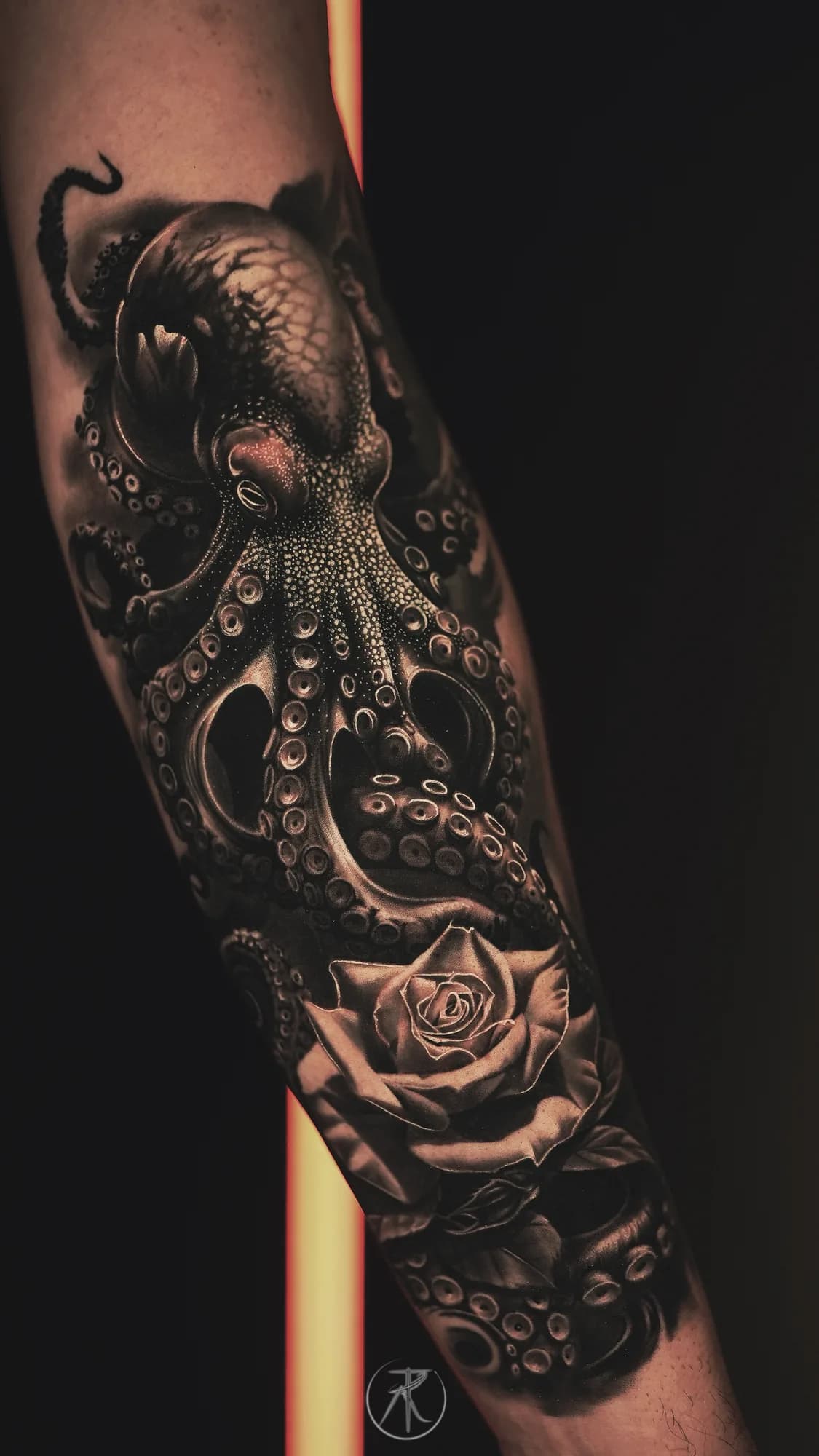 Black and grey octopus and rose forearm tattoo by Taro Bushido