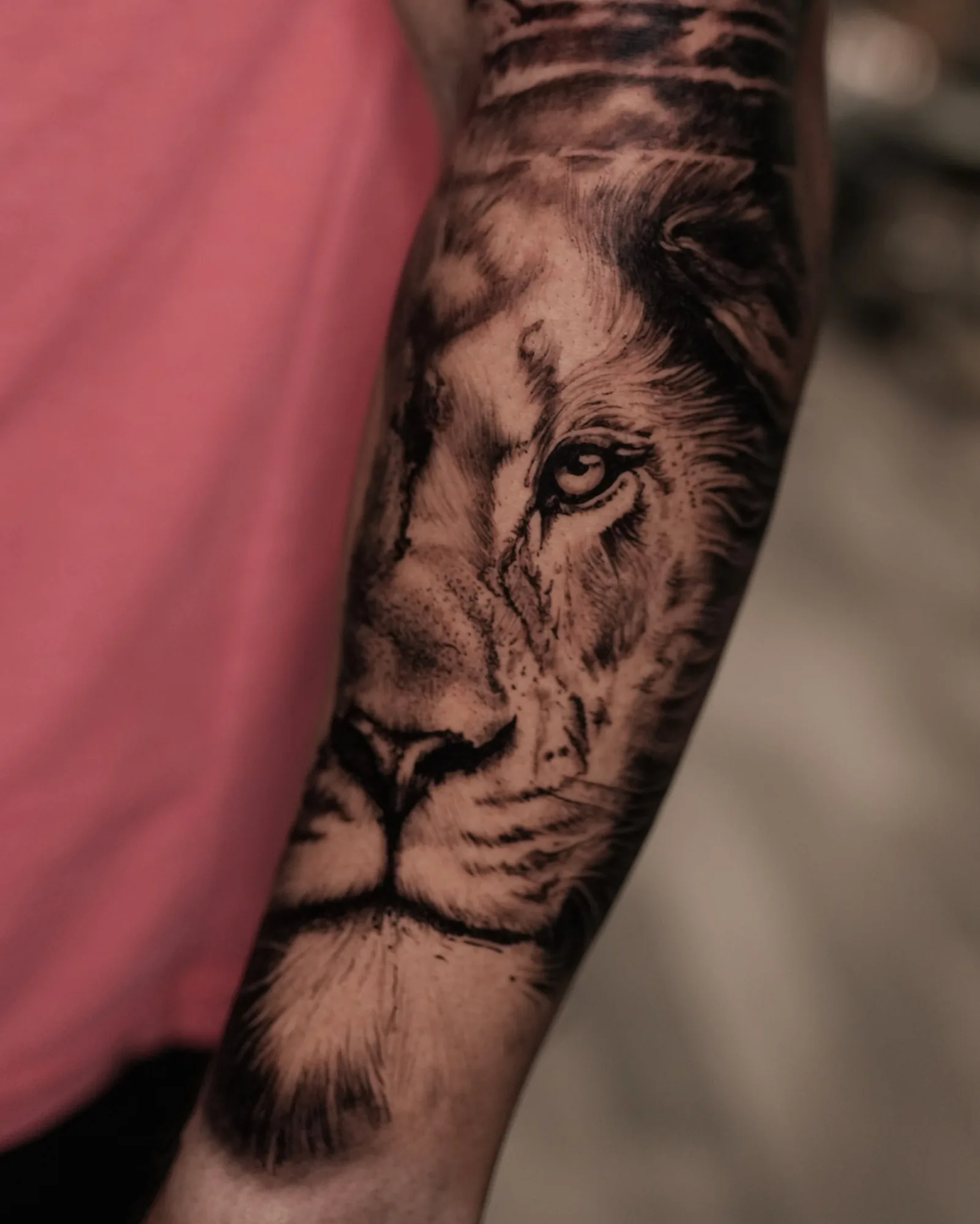 Black and grey realism lion forearm tattoo by Zach Truitt